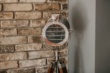 Close-up of lighting equipment or spotlight against a brick wall indoorsの写真素材