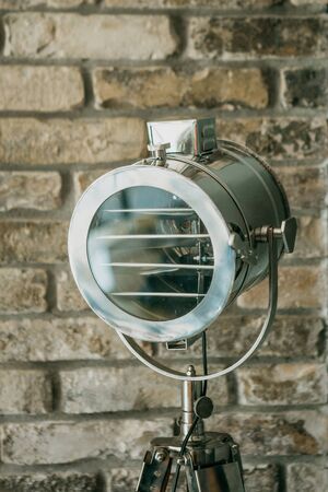 Close-up of lighting equipment or spotlight against a brick wall indoorsの写真素材