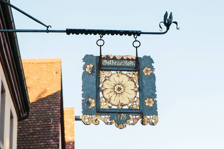 Germany, Rothenburg ob der Tauber, December 30, 2018: Authentic old or retro or vintage signboard on a building facade.のeditorial素材