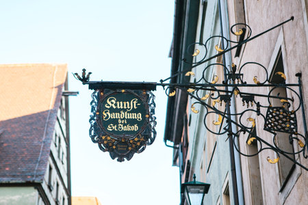 Germany, Rothenburg ob der Tauber, December 30, 2018: Authentic old or retro or vintage signboard on a building facade.のeditorial素材