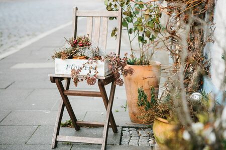 Faded flowers in a box or pot on the street. They were used as decoration, but in the fall became fadedの写真素材