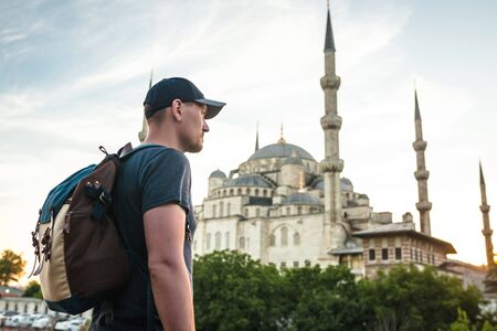 Tourist with a backpack on the background of the Blue Mosque in Istanbul in Turkey. Sightseeing.の写真素材