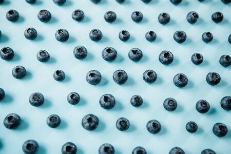 Useful and tasty blueberries on a blue background. Berry or fruit background.の写真素材