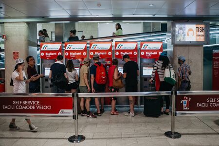 Italy, Milan, July 12, 2019: People buy tickets at self-service machines at the train station in Milan.のeditorial素材