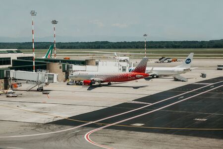 Italy, Milan, July 12, 2019: Airplanes and architecture at the Malpensa Airport in Milan.のeditorial素材