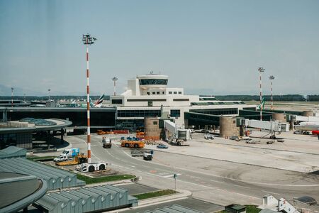 Italy, Milan, July 12, 2019: Airplanes and flight control center and other architecture at the Malpensa Airport in Milan.のeditorial素材