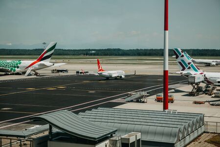 Italy, Milan, July 12, 2019: Airplanes and architecture at the Malpensa Airport in Milan.のeditorial素材