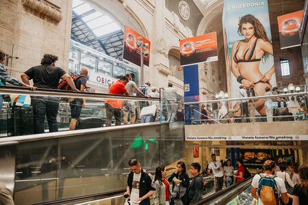 Italy, Milan, July 12, 2019: View of the interior and a lot of people using the escalator at the train station in Milan.のeditorial素材