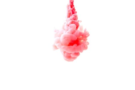 Abstract fluid liquid or coral color ink in water on a white background.の写真素材