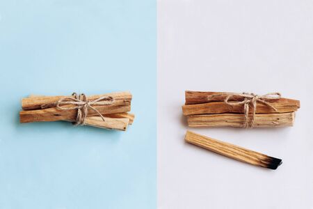 Palo Santo sticks on a white and blue background. They are used in aromatherapy and religious rites and meditations.の写真素材