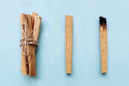 Palo Santo sticks on a blue background. They are used in aromatherapy and religious rites and meditations.の写真素材
