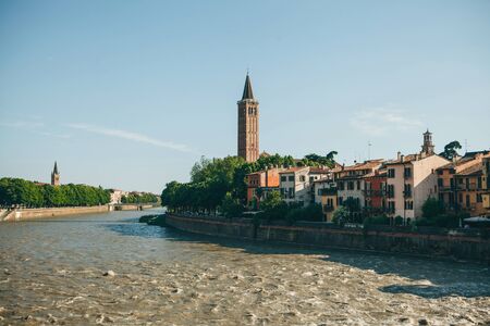 View of traditional old houses and a cathedral or church and river in Verona in Italy.の写真素材