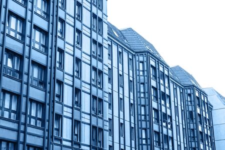 A residential building in trendy classic blue color with cut out sky with white isolated background.の写真素材