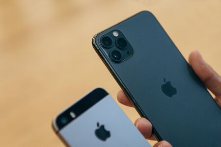 Turkey, Istanbul, December 17, 2019: A person compares the camera on an old iPhone and the newest modern iPhone 11 pro max.のeditorial素材