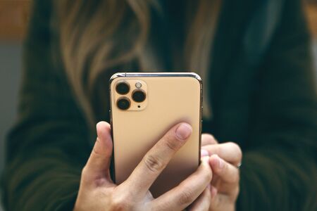 Turkey, Istanbul, December 17, 2019: The girl uses the new modern iPhone 11 pro max with three cameras from Apple.のeditorial素材