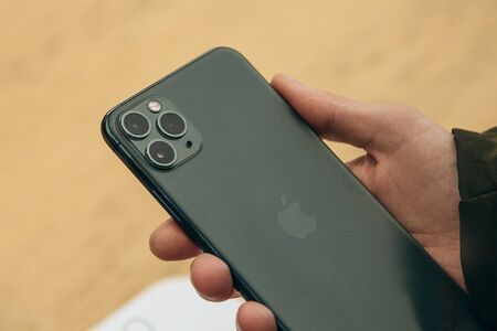 Turkey, Istanbul, December 17, 2019: Close-up of a person holding the latest modern iPhone 11 pro max with three cameras.のeditorial素材