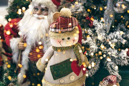Christmas holiday background with a snowman and Santa Claus and other Christmas baubles and lights.の写真素材