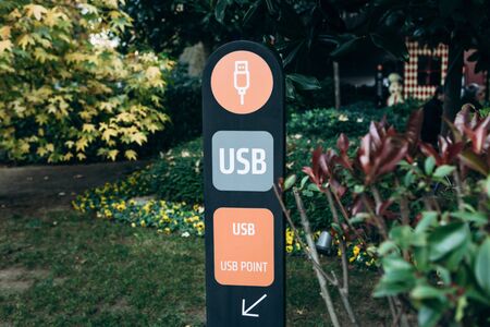 Pointer or sign of USB point in a public park or streetの写真素材