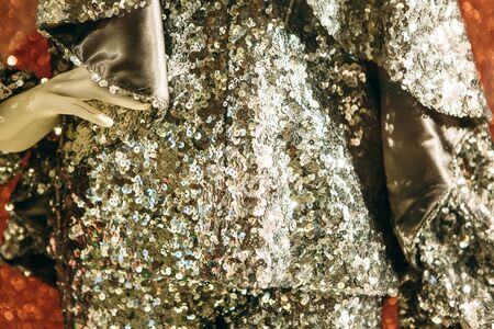 Closeup luminous silver decorated texture of clothes on a mannequin. Modern fashion concept.の写真素材