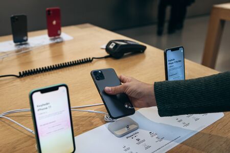 Turkey, Istanbul, December 17, 2019: The buyer selects a new iPhone in the Apple store. The choice settled on the new iPhone 11 pro.のeditorial素材