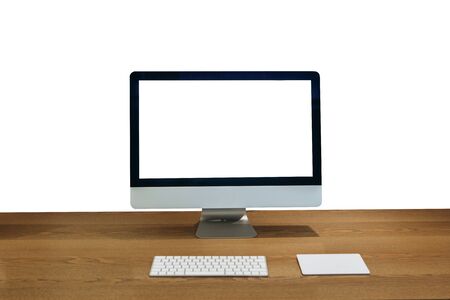 Modern personal computer on a wooden table with a white white screen for mock up and isolated white background.の写真素材
