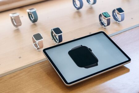 Turkey, Istanbul, December 20, 2019: Apple watch 5 series on a tablet is an advertisement or an offer, and in the background Apple watch in an official storeのeditorial素材