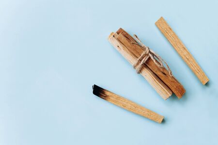 Palo Santo sticks on a blue background. They are used in aromatherapy and religious rites and meditations.の写真素材