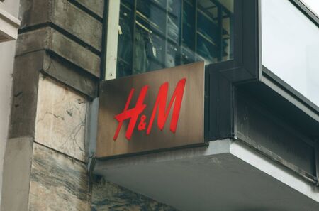 Italy, Milan, May 30, 2019: HM company sign at the entrance to the store.のeditorial素材