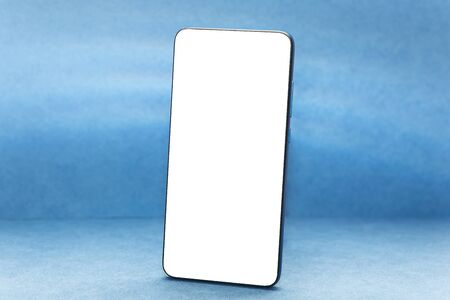 Frameless phone mockup on trendy classic blue background.の写真素材