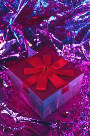 Gift box on a trendy glowing red background.の写真素材