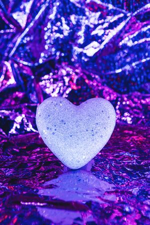 Heart on a trendy glowing neon background. Valentine's day celebration or wedding concept or other love event.の写真素材