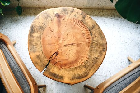 Wooden round cut of wood table or table surface in cozy cafe top viewの写真素材