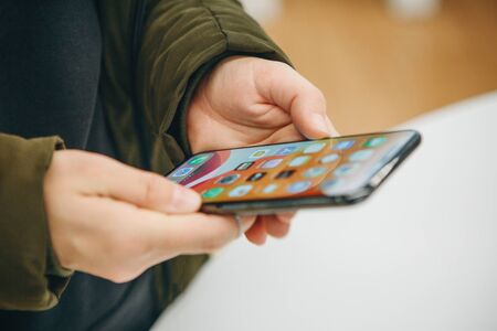 Turkey, Istanbul, January 27, 2020: A girl uses the new Apple with an 11 model phone with a dual camera.のeditorial素材