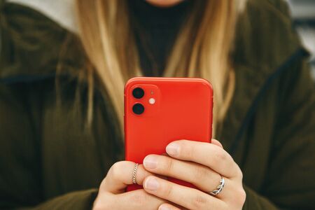 The girl uses a new cell phone with a dual camera.の写真素材