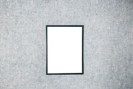 Mock up frame for a picture or photograph on a gray wall in Scandinavian style.