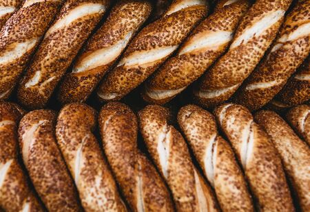 Close up of many traditional turkish bagels called simit. Traditional street food.