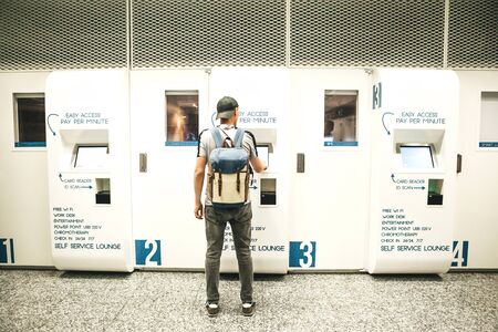 A tourist uses a self service lounge or a smart lounge at the airport for relaxation.の写真素材