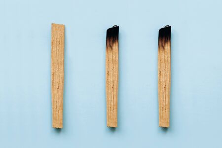 Palo Santo sticks on a blue background. They are used in aromatherapy and religious rites and meditations.の写真素材