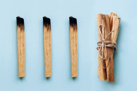 Palo Santo sticks on a blue background. They are used in aromatherapy and religious rites and meditations.の写真素材