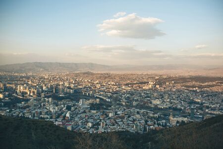 Beautiful panoramic view of Tbilisi, Georgia. The city near the mountains against the sky with clouds.の写真素材