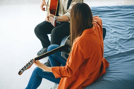 Learning to play the guitar. The teacher explains to the student the basics of playing the guitar....