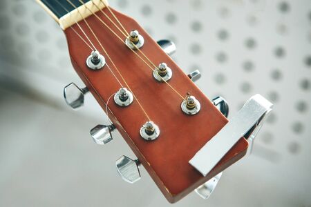 Close-up of a fretboard guitar with strings. The concept of learning to play the guitar.の写真素材