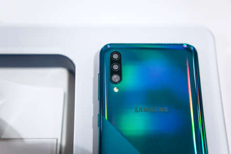 Turkey, Istanbul, December 20, 2019: Close-up of the back cover or rear view of the new modern Samsung A70 smartphone with three cameras.のeditorial素材