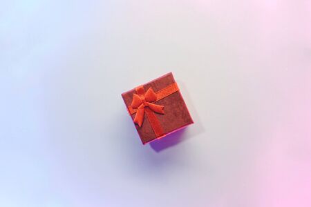 Red gift box on a gradient background.の写真素材