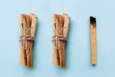 Palo Santo sticks on a blue background. They are used in aromatherapy and religious rites and meditations.の写真素材