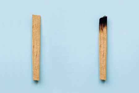 Palo Santo sticks on a blue background. They are used in aromatherapy and religious rites and meditations.の写真素材