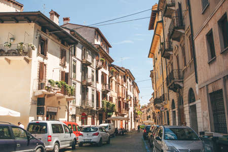 Italy, Verona, June 01, 2019: View of a traditional Italian street with ancient architecture. Many cars are parked on this street.のeditorial素材