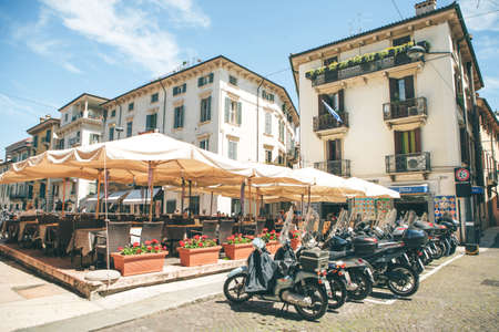 Italy, Verona, June 01, 2019: View of a street cafe restaurant or pizzeriaのeditorial素材