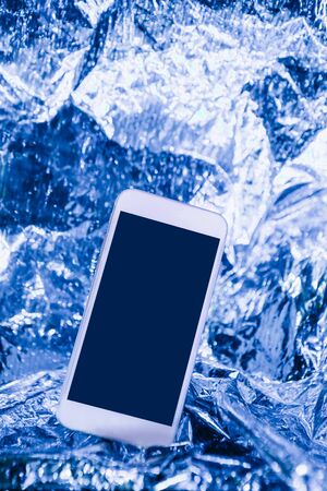 Cell phone mockup with blank screen or copy space on trendy blue neon background.の写真素材