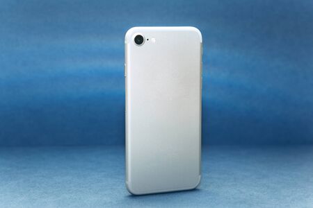 Rear view cell phone with camera on a blue background.の写真素材